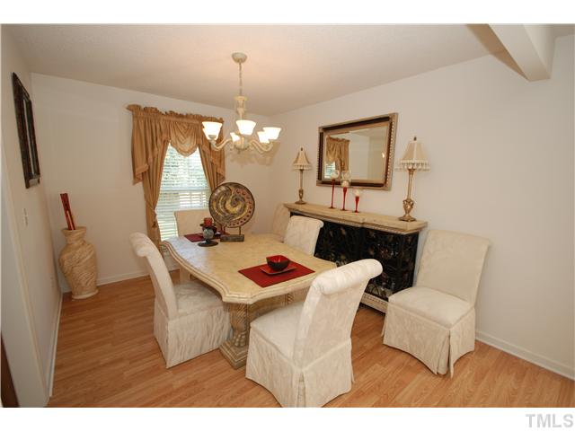 4105 Mantua Way Raleigh, NC 27604 - Photo 6 of 25 a dining room with furniture a chandelier and window
