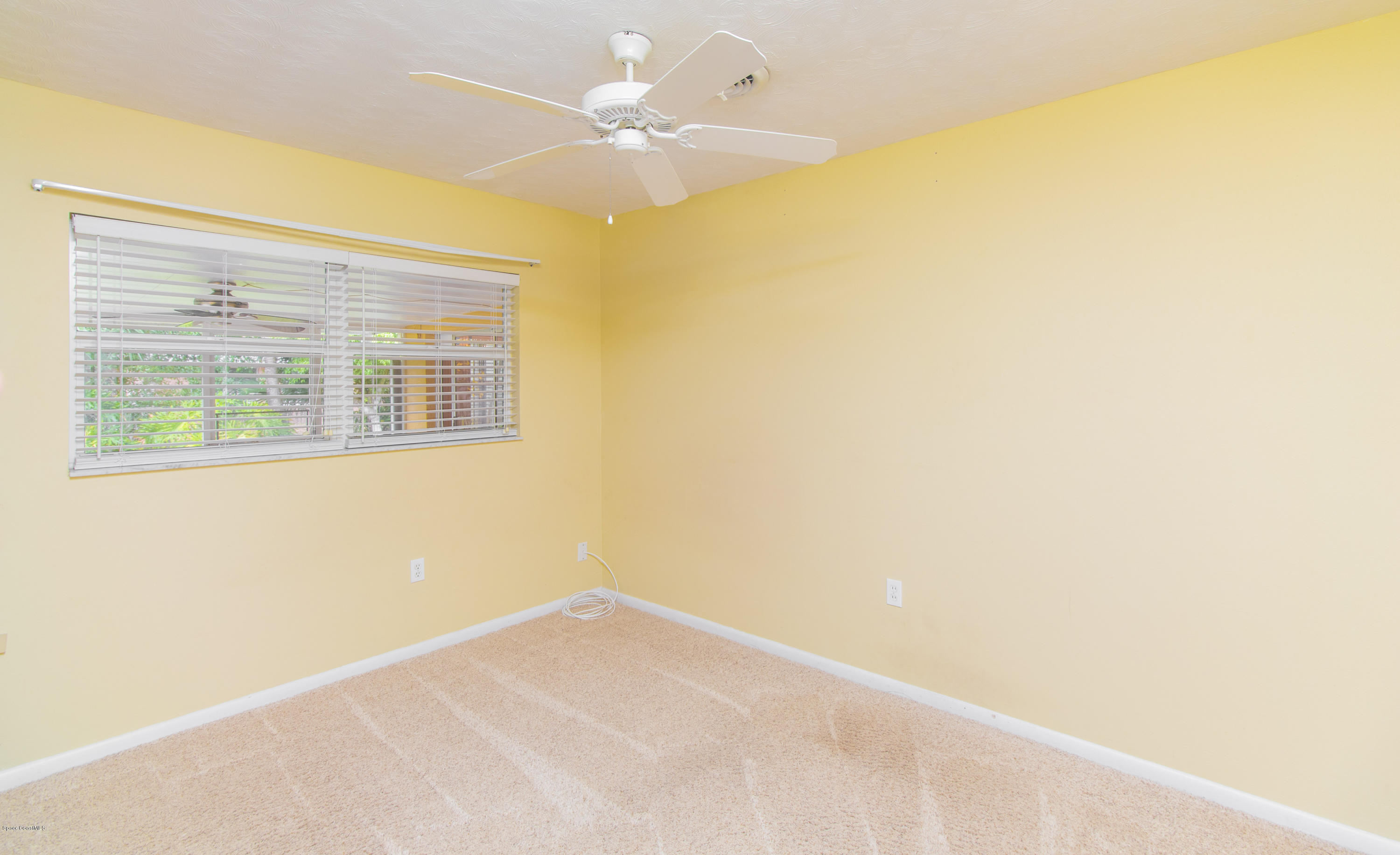 1054 Bali Road Cocoa Beach, FL 32931 - Photo 16 of 24 an empty room with a window
