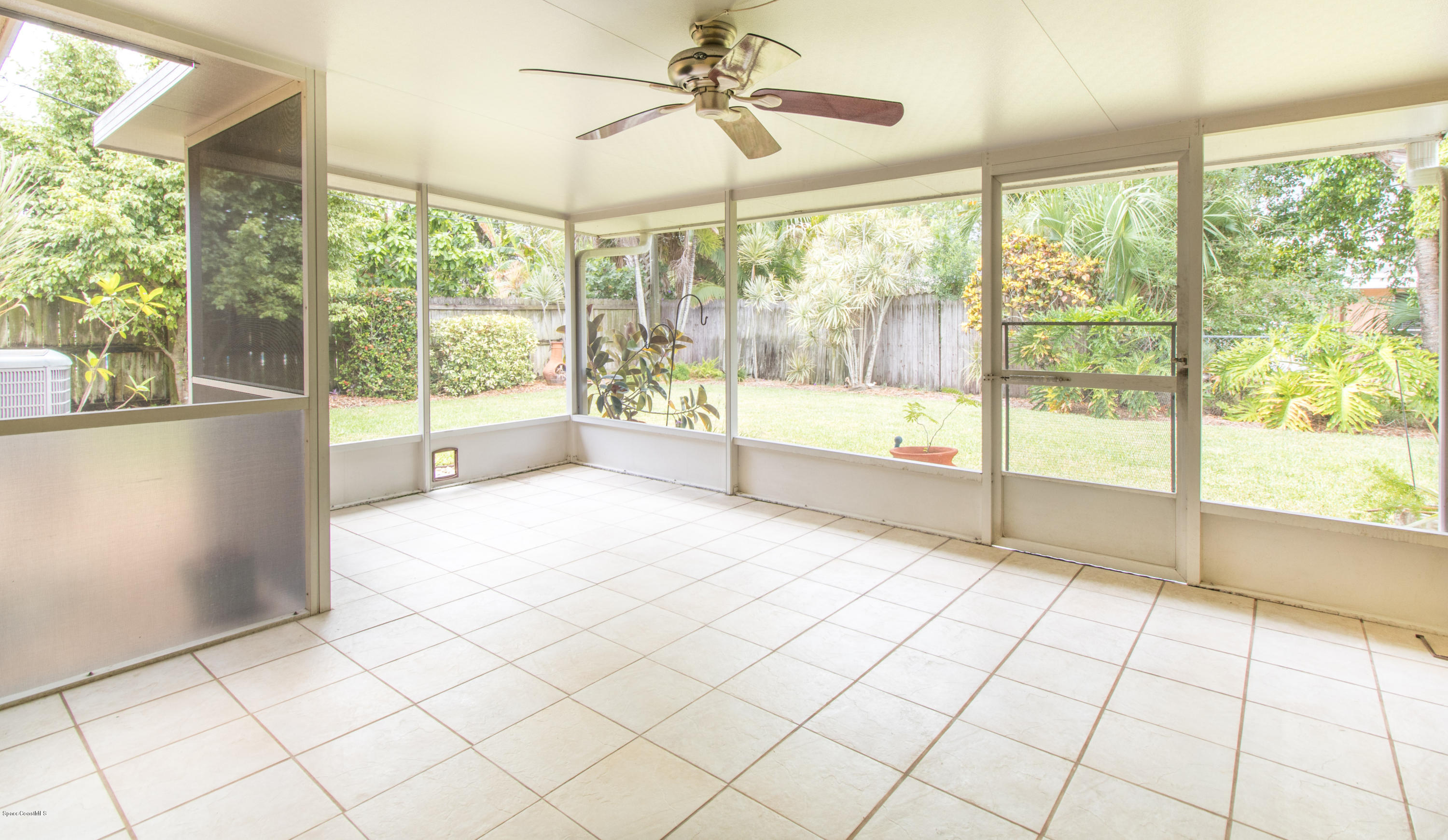 1054 Bali Road Cocoa Beach, FL 32931 - Photo 19 of 24 a view of an empty room and window a ceiling fan