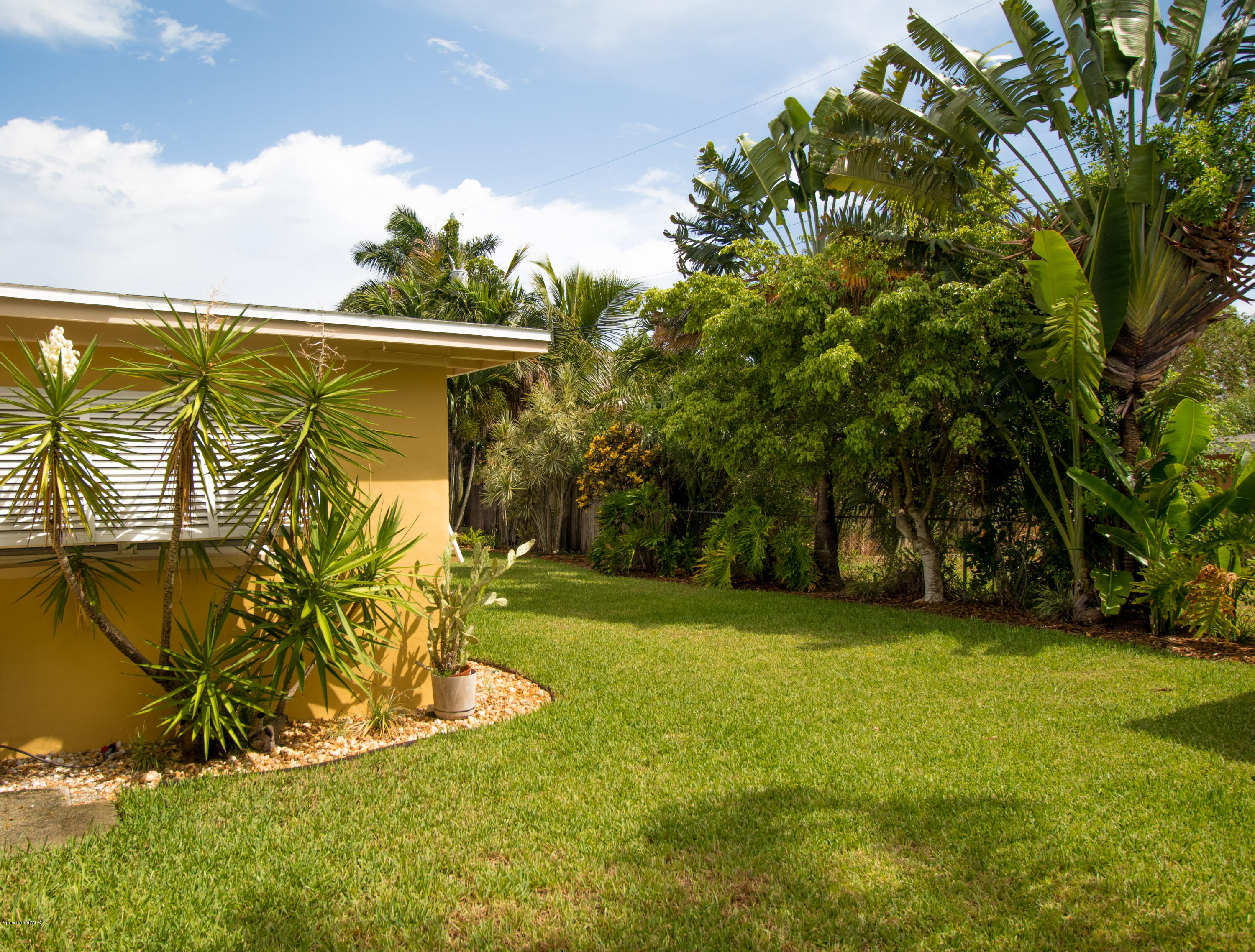 1054 Bali Road Cocoa Beach, FL 32931 - Photo 20 of 24 a view of swimming pool with a yard