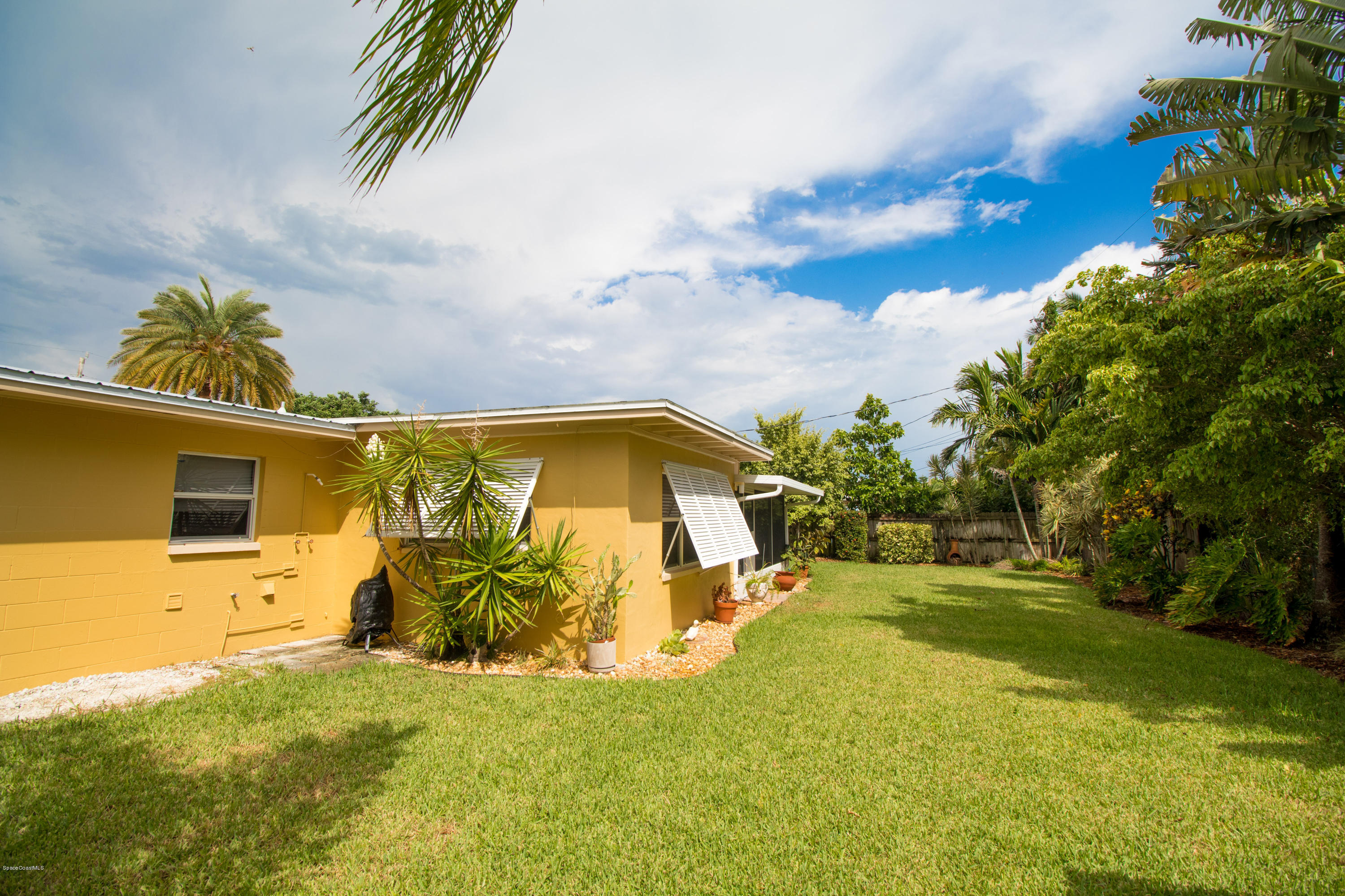 1054 Bali Road Cocoa Beach, FL 32931 - Photo 22 of 24 a view of a house with a yard