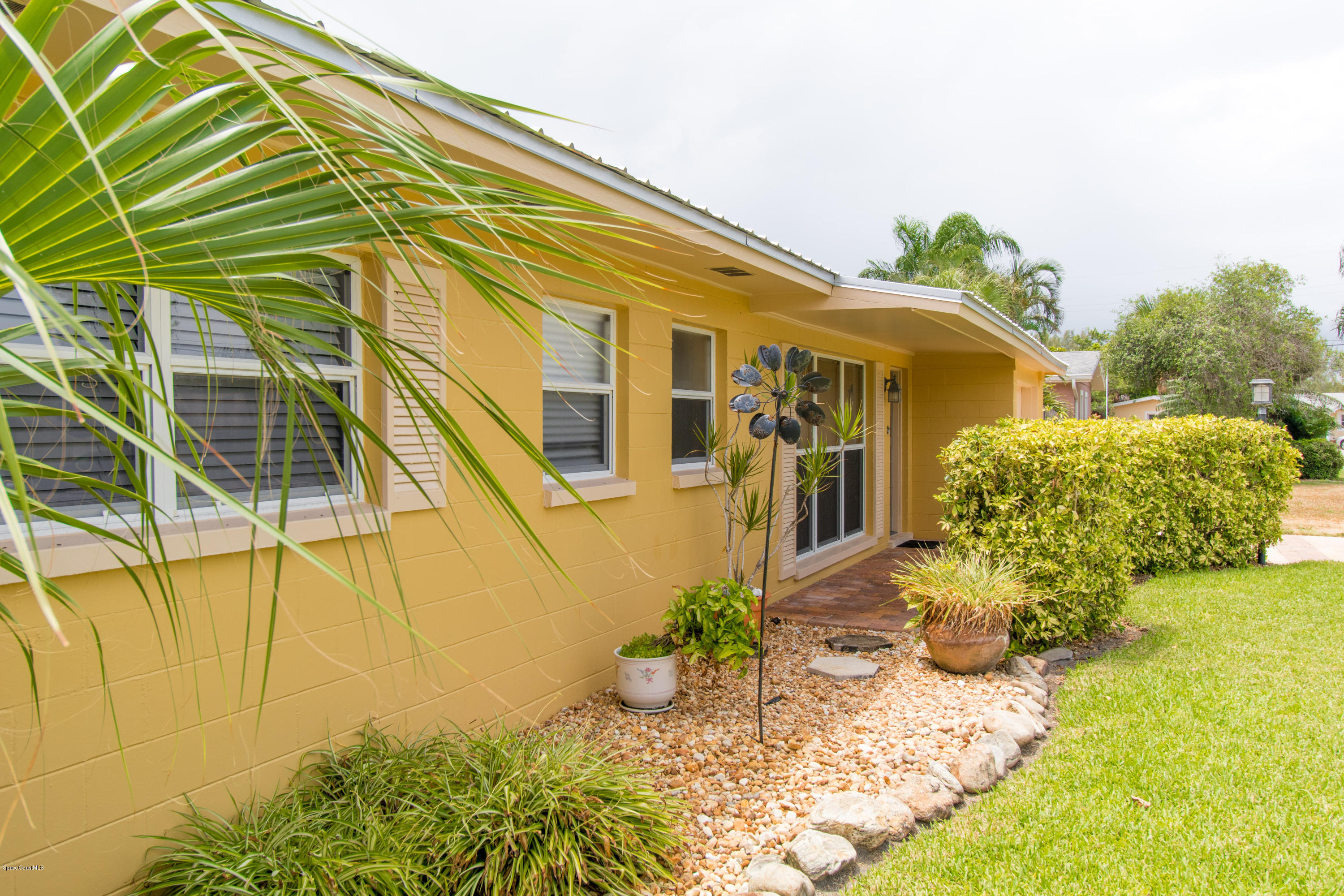 1054 Bali Road Cocoa Beach, FL 32931 - Photo 5 of 24 a front view of a house with a yard