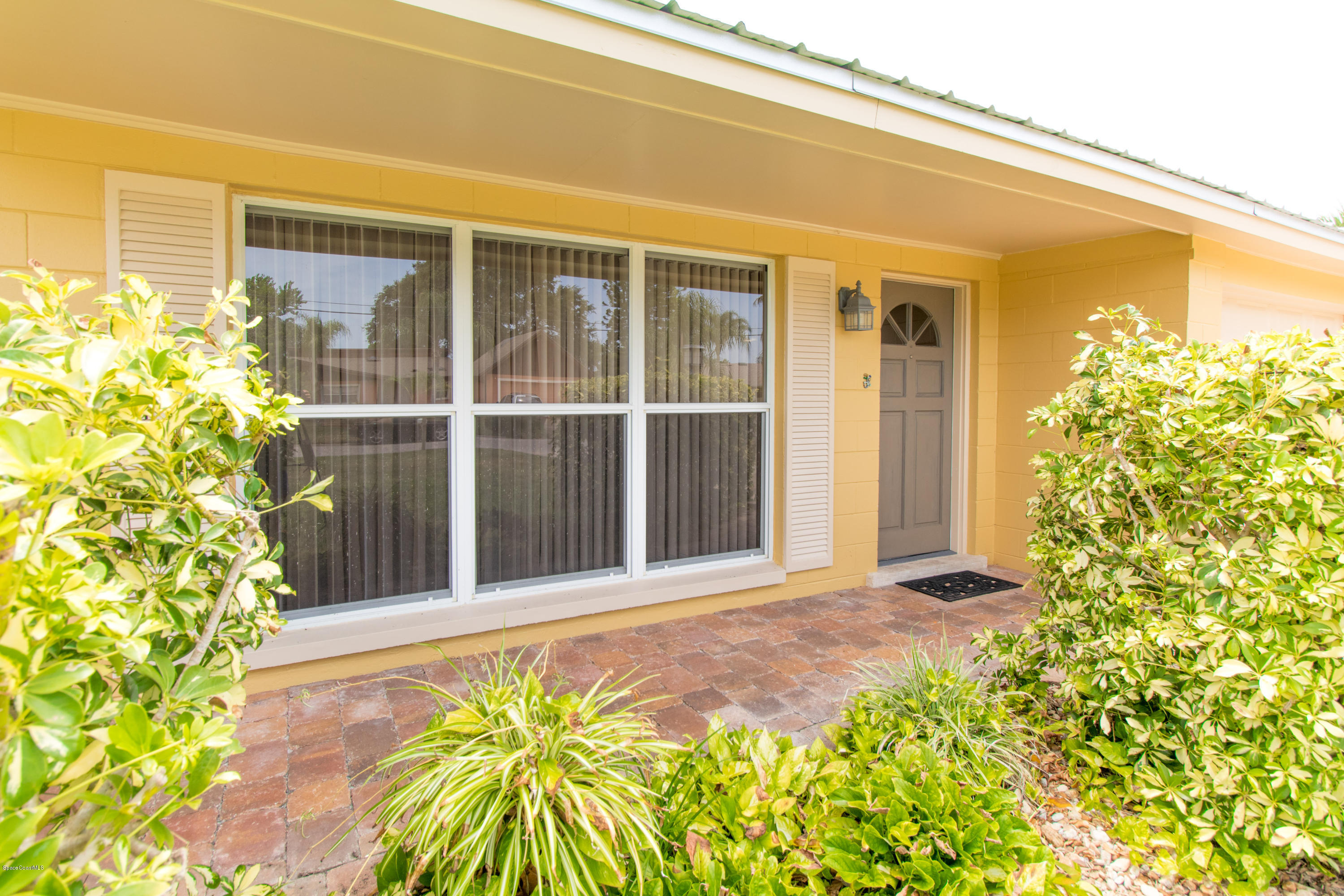 1054 Bali Road Cocoa Beach, FL 32931 - Photo 6 of 24 a view of a garden with pathway
