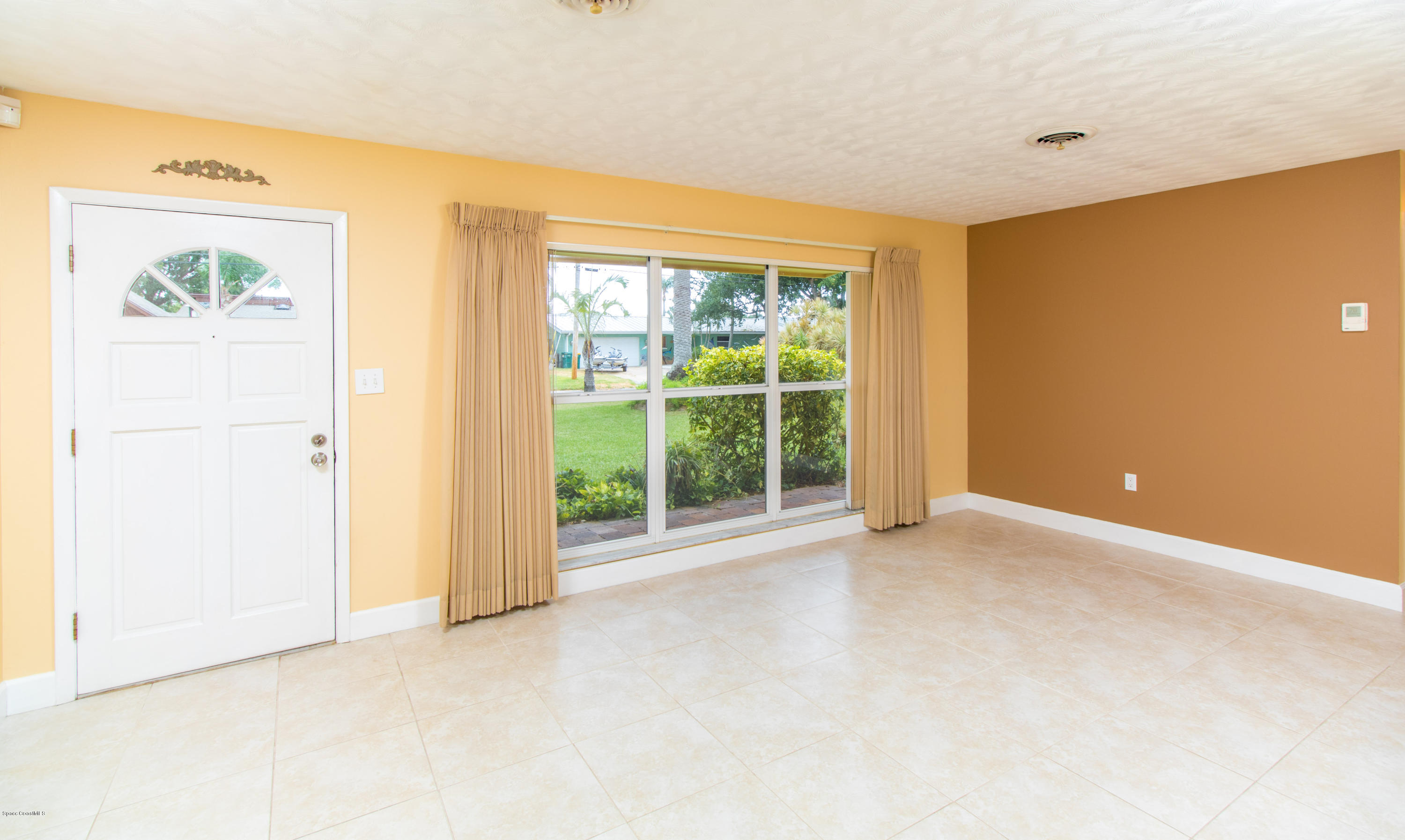 1054 Bali Road Cocoa Beach, FL 32931 - Photo 7 of 24 a view of an empty room with a window