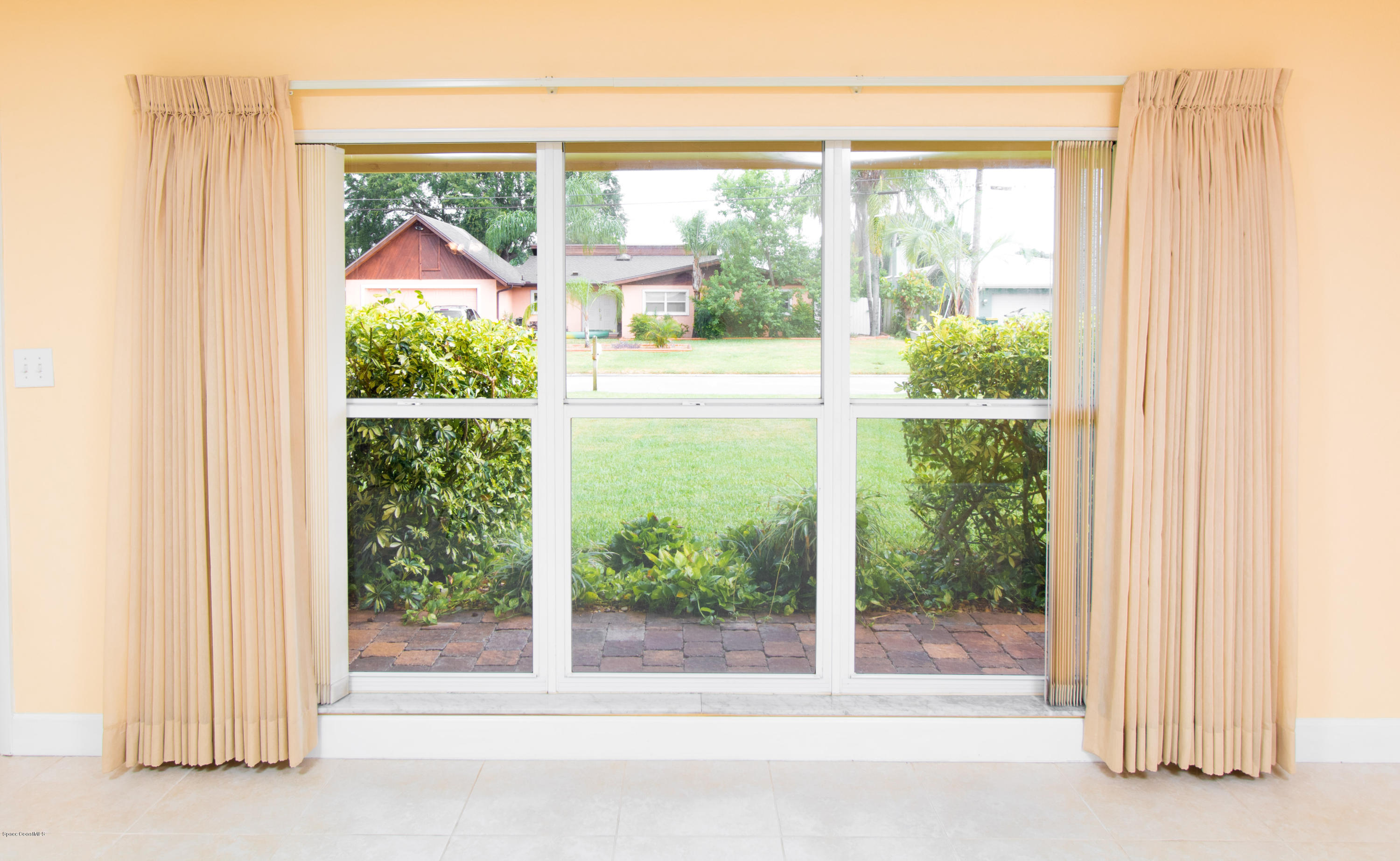 1054 Bali Road Cocoa Beach, FL 32931 - Photo 8 of 24 a view of a glass door and a yard