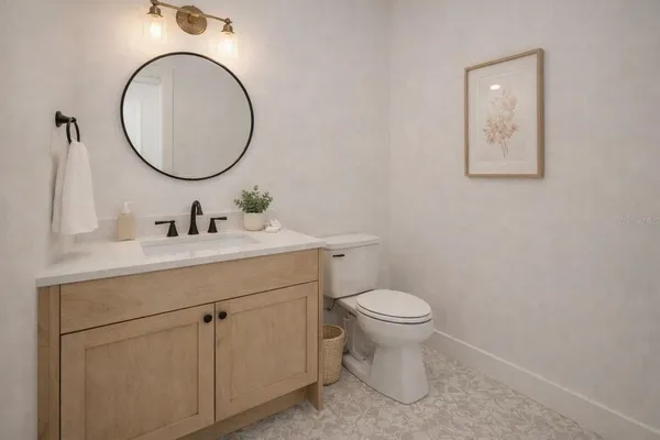 a bathroom with a toilet a sink and a mirror