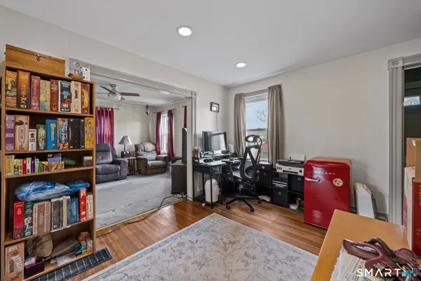 a living room with lots of furniture and book shelf