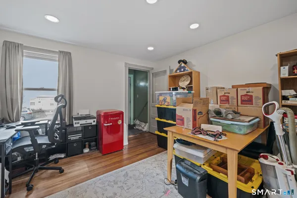 a living room with furniture a rug and gym equipment