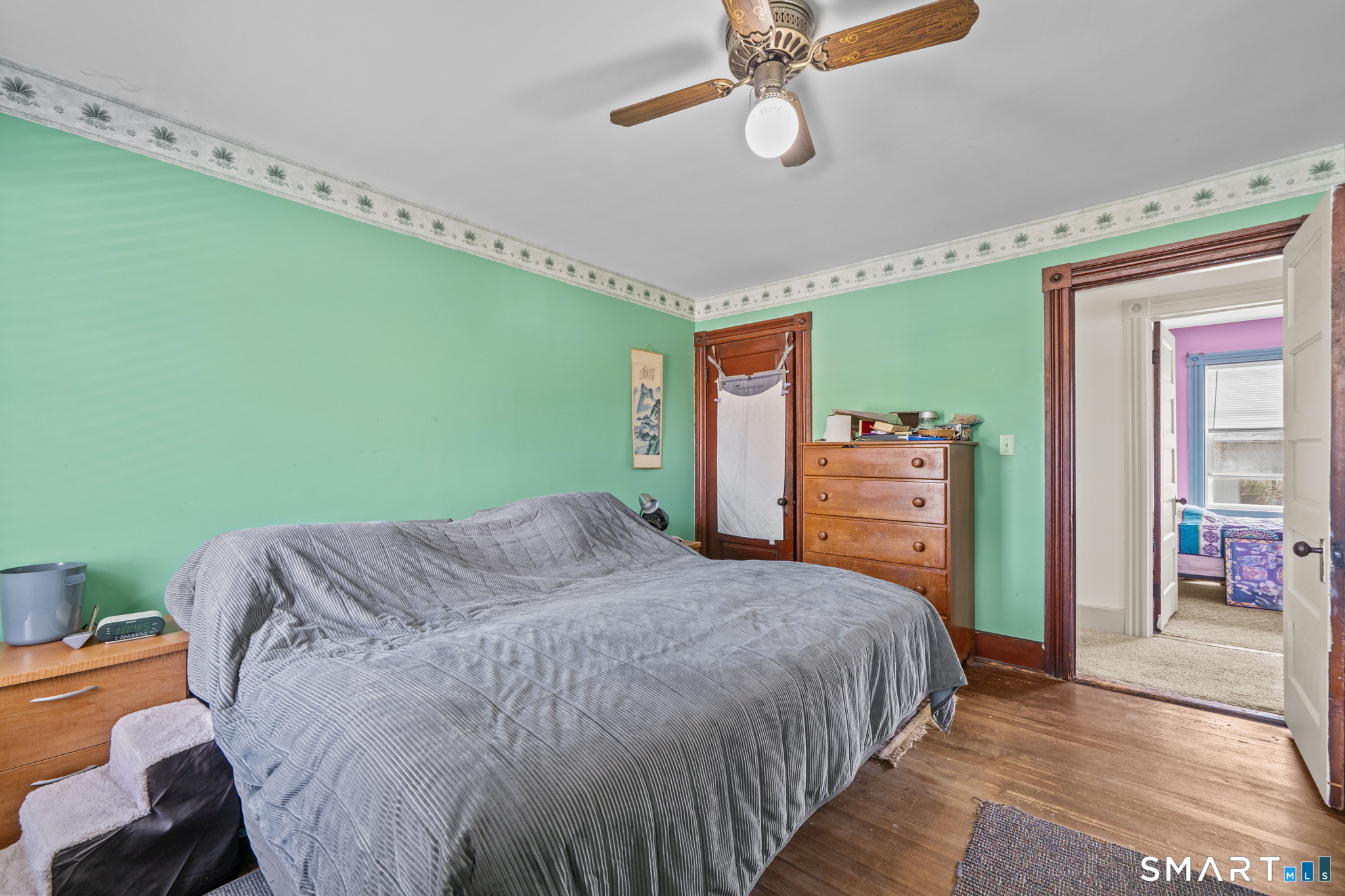 5 8th Street Plainfield, CT 06374 - Photo 17 of 40 a bedroom with a bed and a chandelier