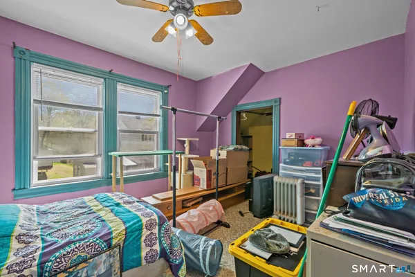 a bedroom with furniture and a window