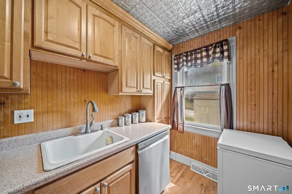 a kitchen with stainless steel appliances granite countertop a sink and a refrigerator