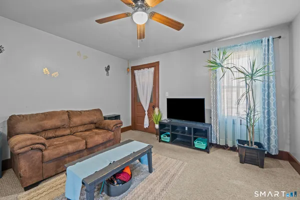 a living room with furniture and a flat screen tv