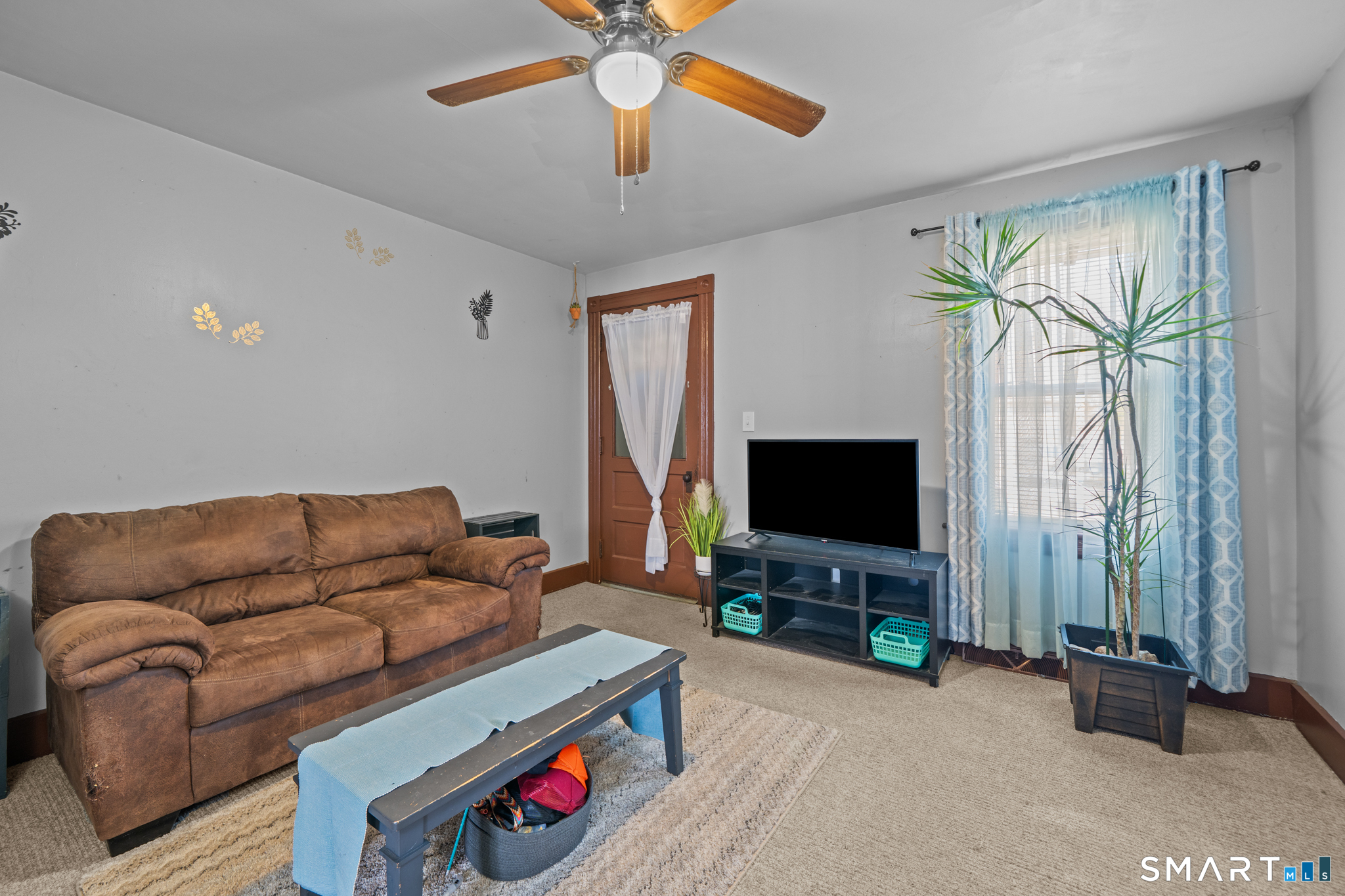 5 8th Street Plainfield, CT 06374 - Photo 23 of 40 a living room with furniture and a flat screen tv