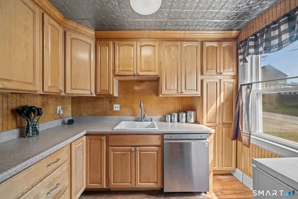 a kitchen with stainless steel appliances granite countertop a sink a stove and a refrigerator