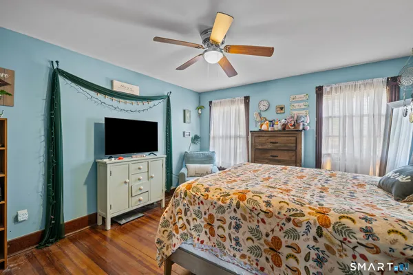 a bedroom with a bed and a flat screen tv
