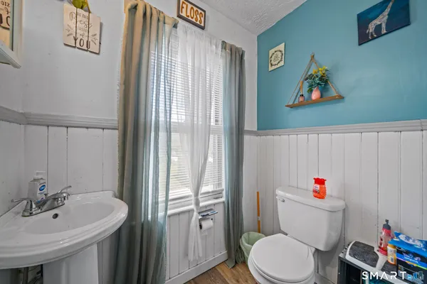 a white toilet sitting next to a bathroom sink