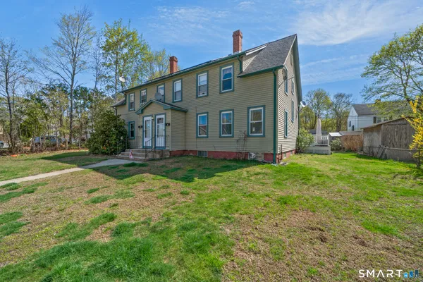 a front view of house with yard and green space