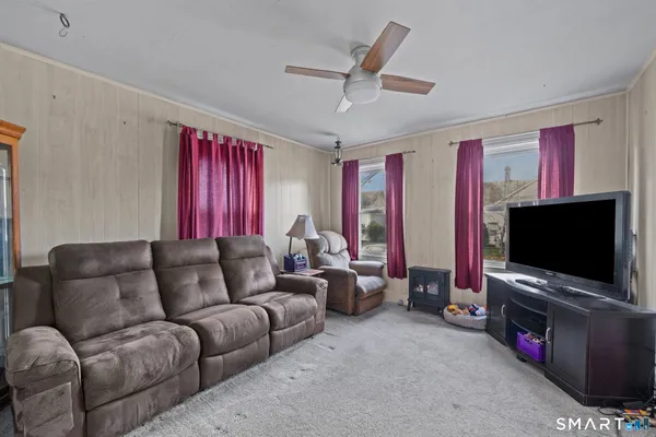 a living room with furniture and a flat screen tv