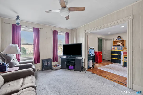 a living room with furniture and a flat screen tv