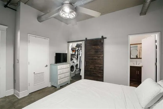 a bedroom with a bed and a television