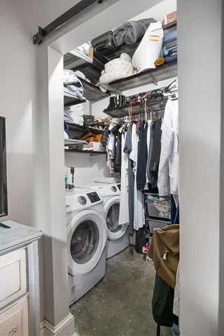 a view of walk in closet with clothes and shoes