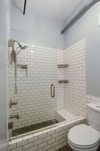 a bathroom with a toilet and shower