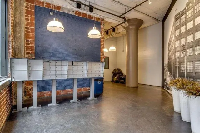 a view of an empty room with a fireplace and a window