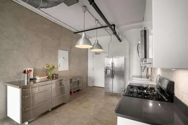 a kitchen with cabinets and white appliances