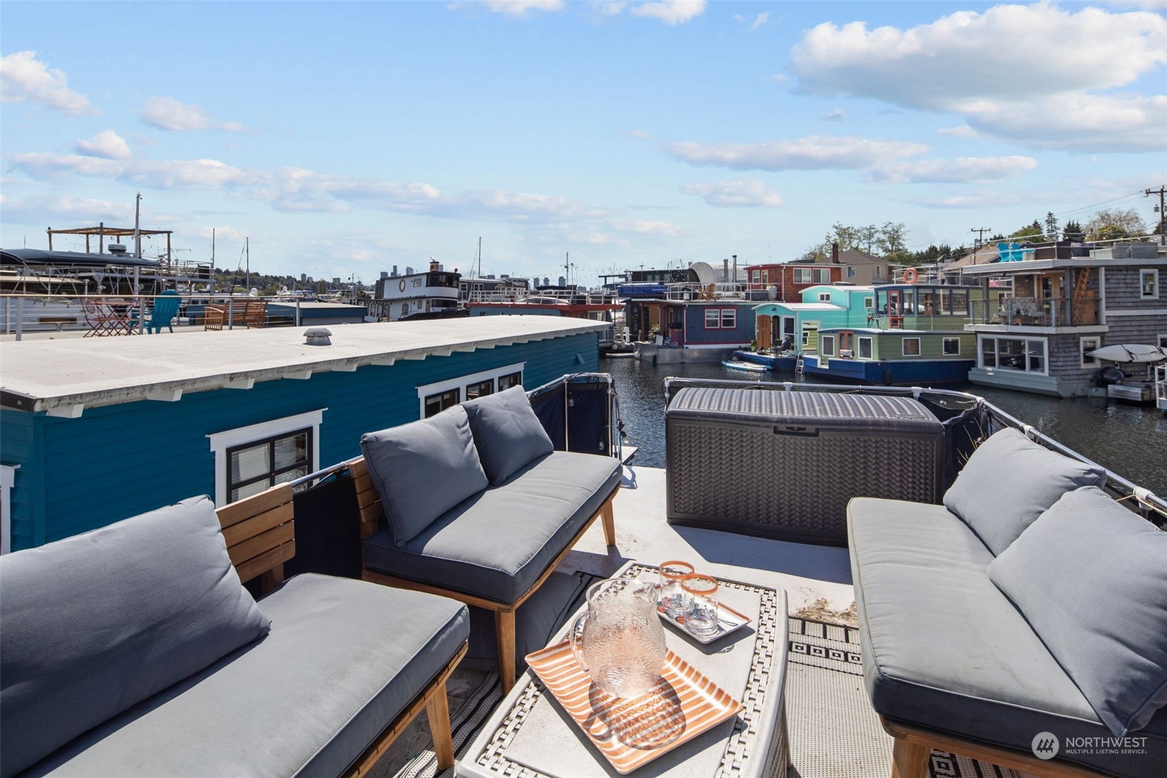 2401 North Northlake Way, Unit E6 Seattle, WA 98103 - Photo 20 of 25 a couple of chairs sitting in a roof deck with a barbeque and furniture