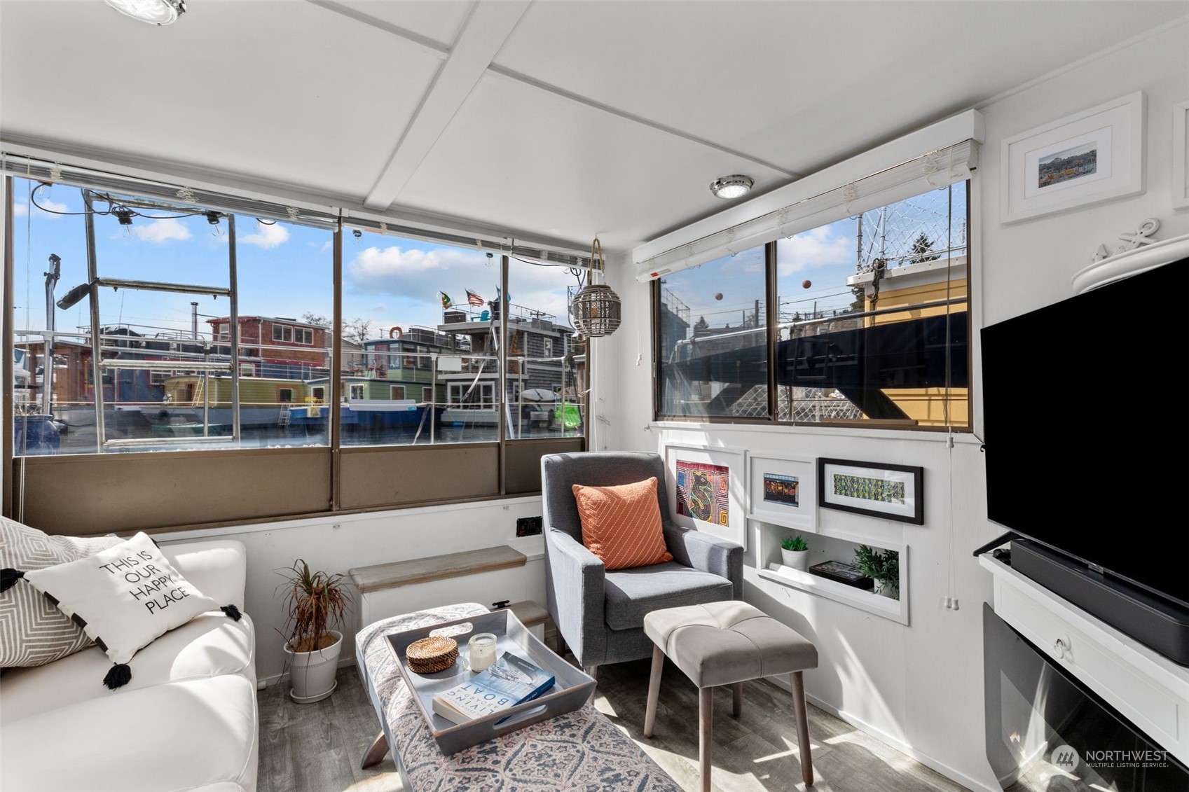 2401 North Northlake Way, Unit E6 Seattle, WA 98103 - Photo 2 of 25 a living room with furniture and a flat screen tv