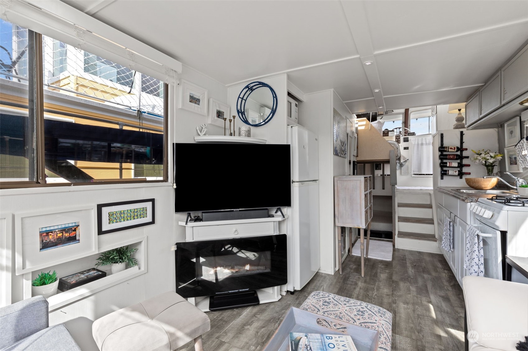 2401 North Northlake Way, Unit E6 Seattle, WA 98103 - Photo 5 of 25 a living room with furniture a flat screen tv and a fireplace