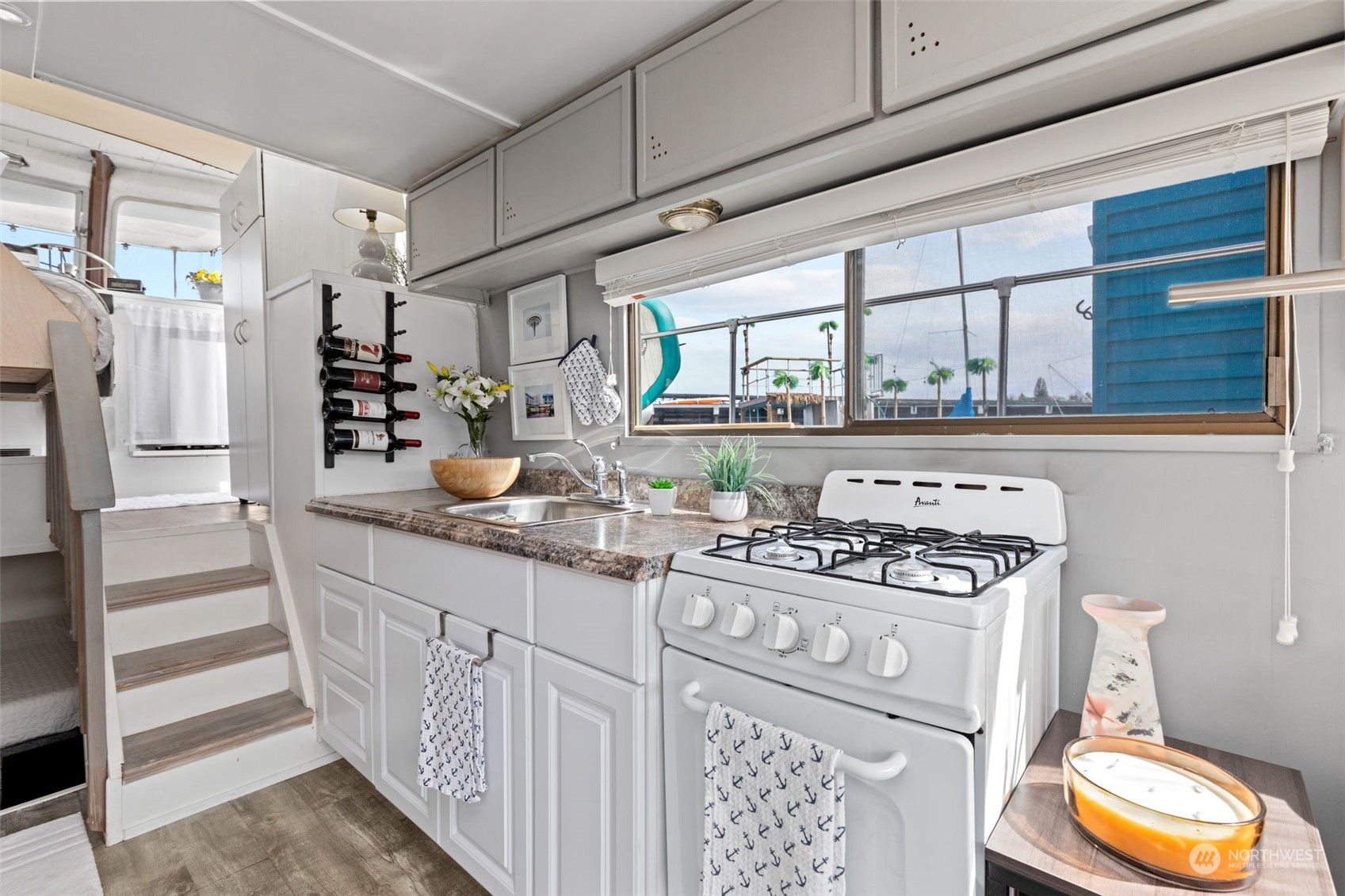 2401 North Northlake Way, Unit E6 Seattle, WA 98103 - Photo 6 of 25 a kitchen with stainless steel appliances granite countertop a stove and a wooden cabinets