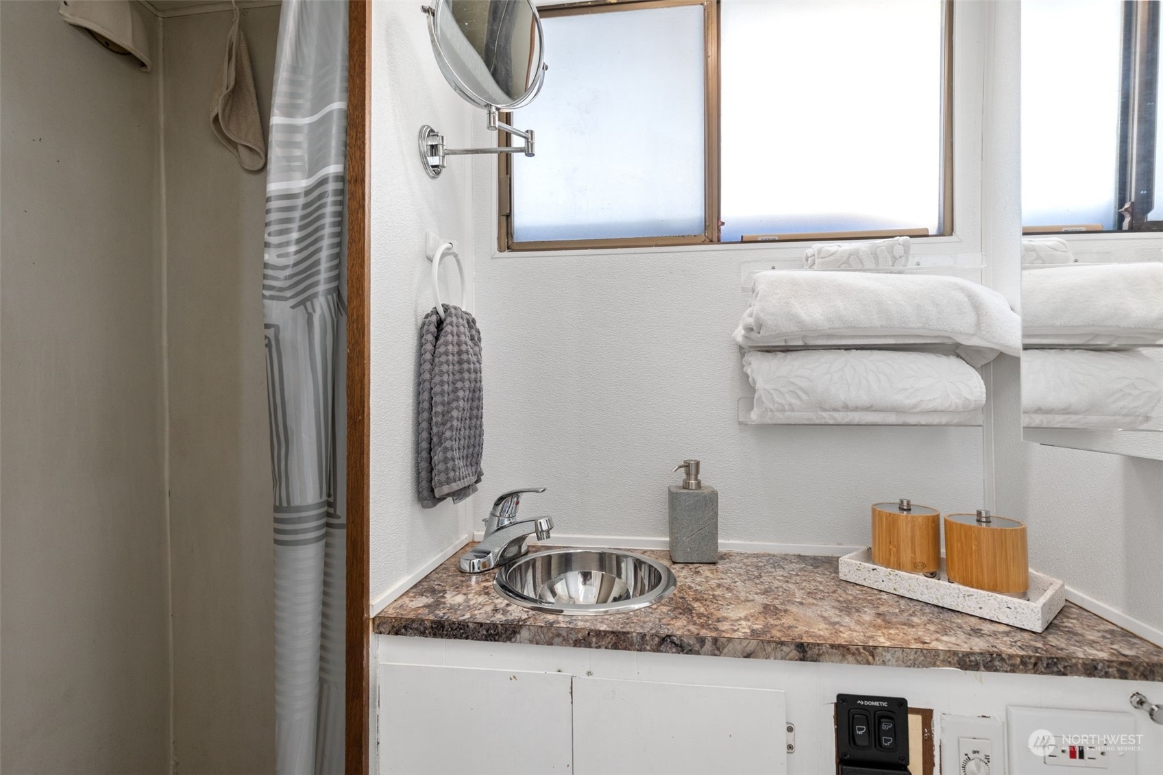2401 North Northlake Way, Unit E6 Seattle, WA 98103 - Photo 9 of 25 a bathroom with a granite countertop sink and a mirror