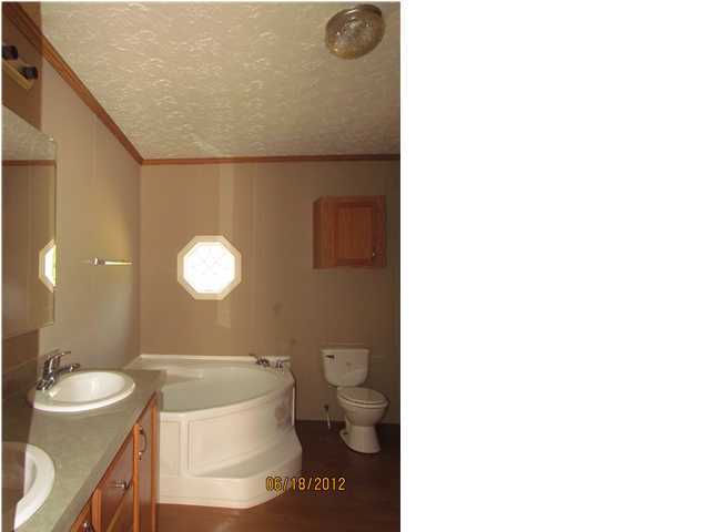 5825 Bush Road Baker, FL 32531 - Photo 14 of 27 a bathroom with a toilet a sink and a bathtub