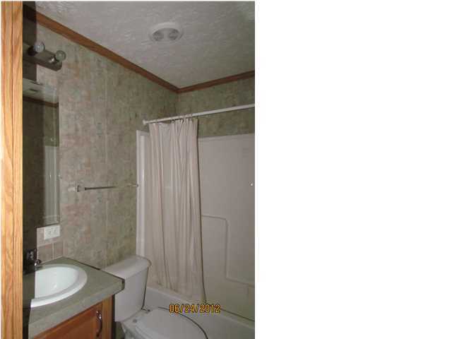 5825 Bush Road Baker, FL 32531 - Photo 24 of 27 a bathroom with a toilet and a shower