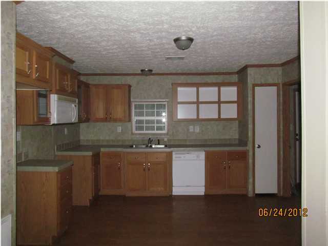 5825 Bush Road Baker, FL 32531 - Photo 4 of 27 a kitchen with a sink and cabinets