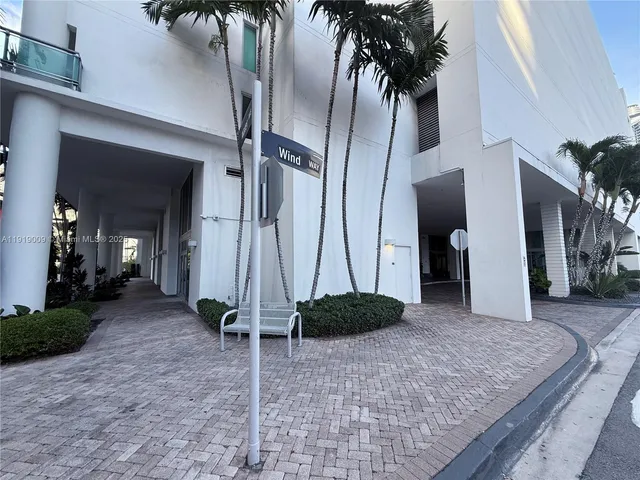 a living room with a couch and a potted plant