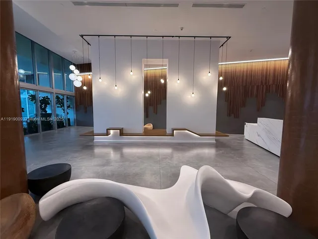 a lobby with furniture and a large mirror