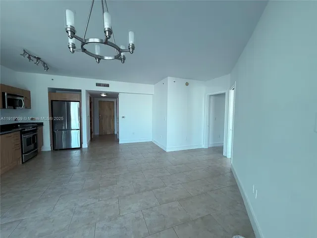 a view of a livingroom with a kitchen