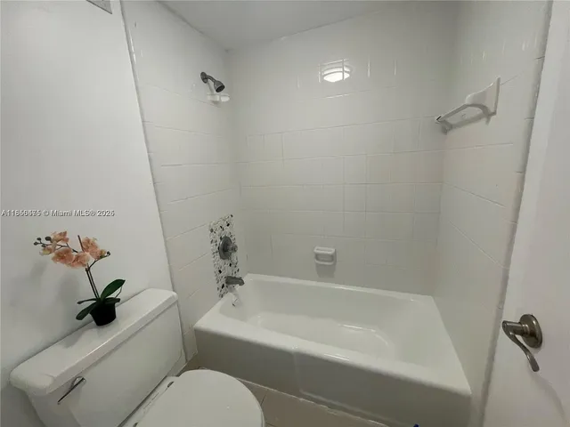 a bathroom with a toilet and a bathtub
