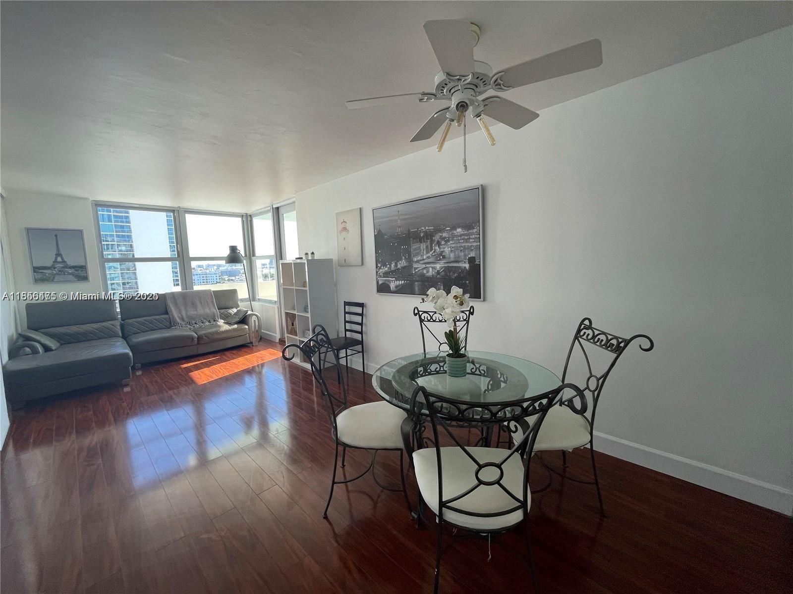 2899 Collins Avenue, Unit 1420 Miami Beach, FL 33140 - Photo 5 of 17 a living room with furniture and a wooden floor