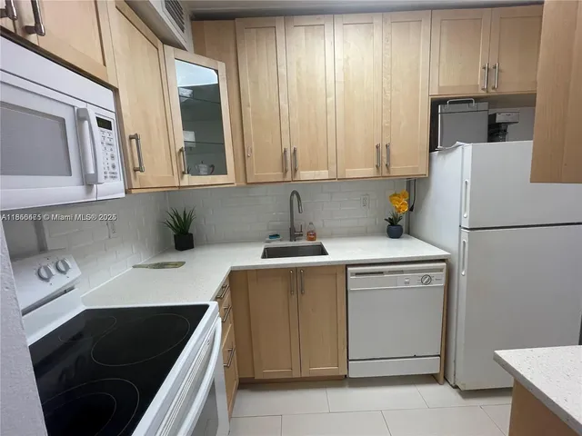 a kitchen with a sink and a refrigerator