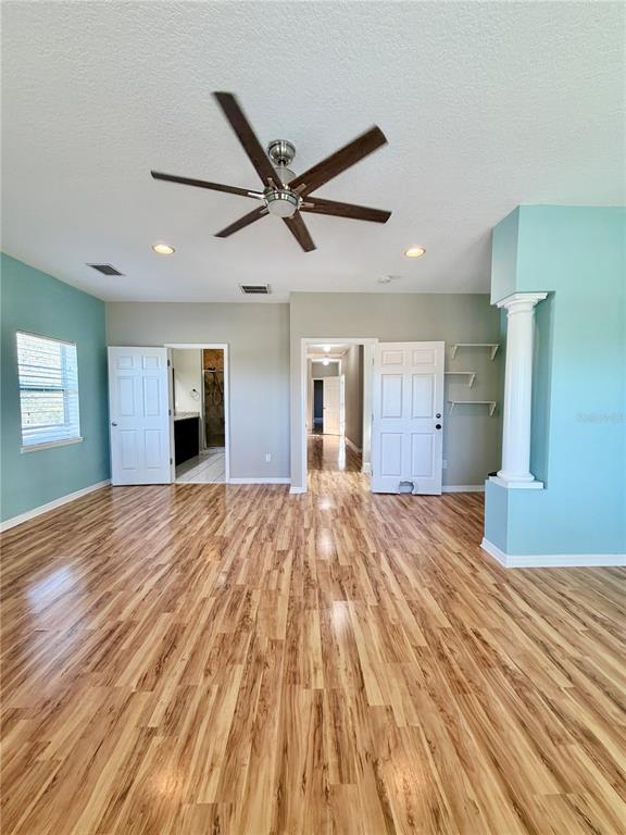 4848 Tampa Downs Boulevard Lutz, FL 33559 - Photo 15 of 27 a big room with wooden floor and windows
