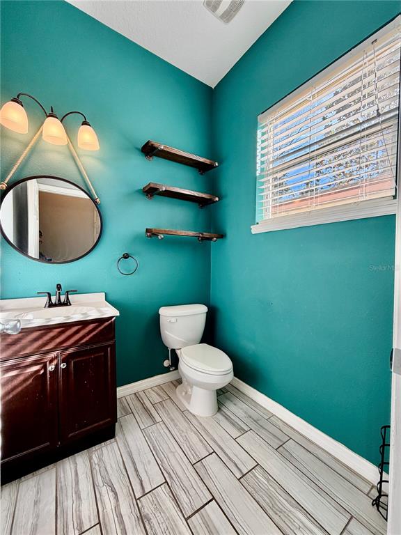 4848 Tampa Downs Boulevard Lutz, FL 33559 - Photo 20 of 27 a bathroom with a toilet a sink and mirror