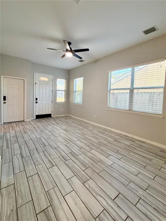 4848 Tampa Downs Boulevard Lutz, FL 33559 - Photo 21 of 27 wooden floor in an empty room with a window