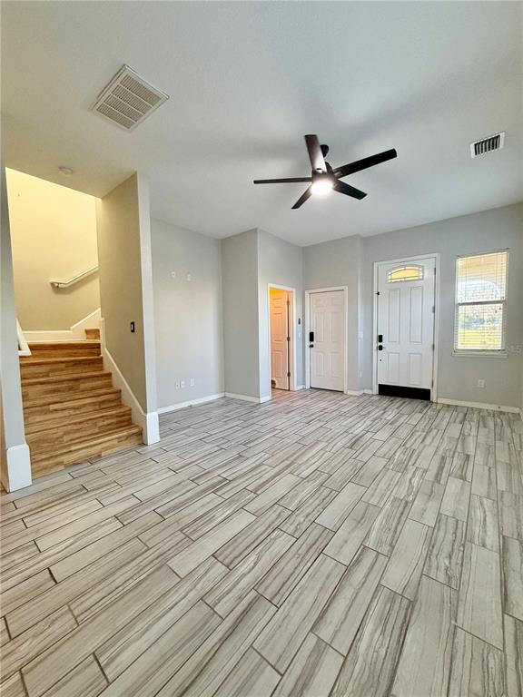 4848 Tampa Downs Boulevard Lutz, FL 33559 - Photo 22 of 27 a view of empty room with wooden floor and fan