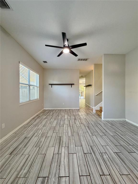 4848 Tampa Downs Boulevard Lutz, FL 33559 - Photo 23 of 27 a view of empty room with wooden floor and fan