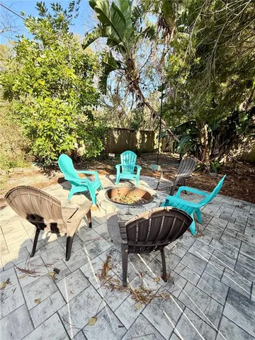 a backyard of a house with table and chairs