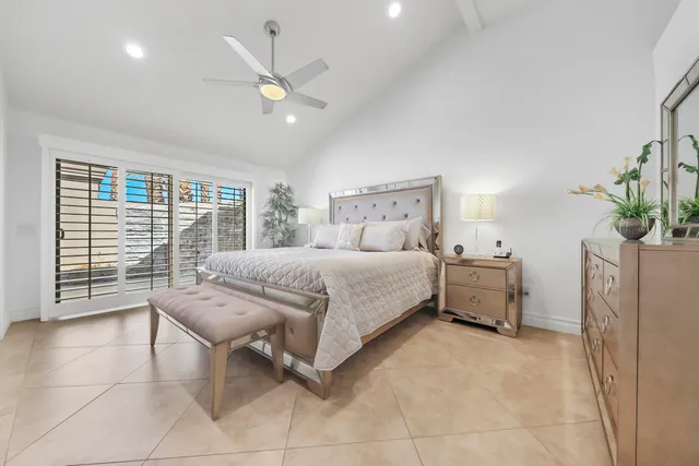 a bedroom with a bed and a large window