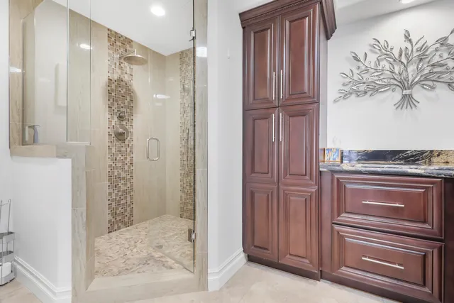 a bathroom with a shower and a mirror